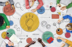 team of people working on light bulb graphic